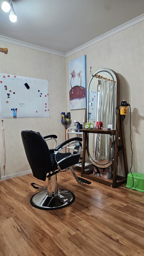Barber Sam's studio with professional barber chair and mirror